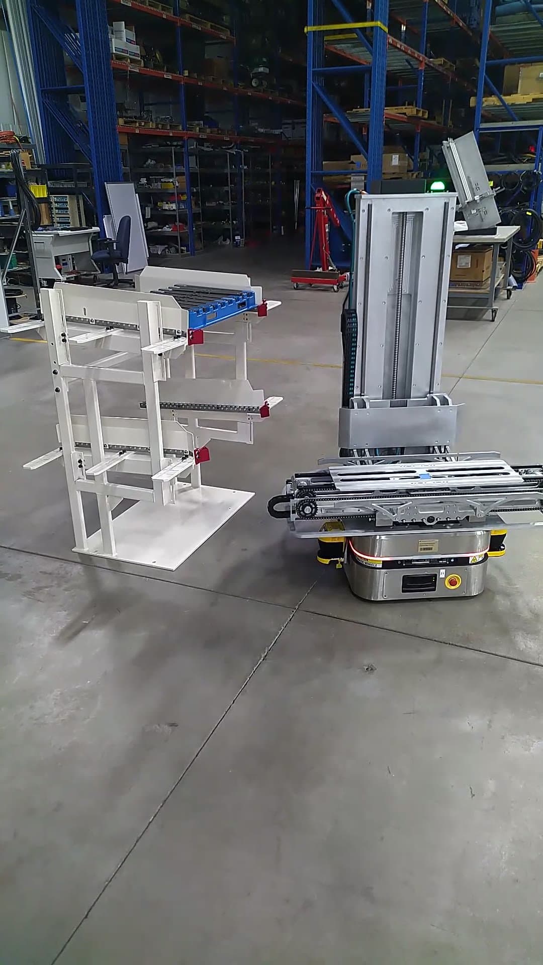 OTTO 100 AMR with custom powered-lift top approaching a tray staging frame